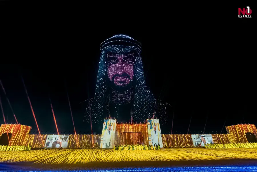 A portrait of Sheikh Zayed rendered in light above the fort set during the ceremony