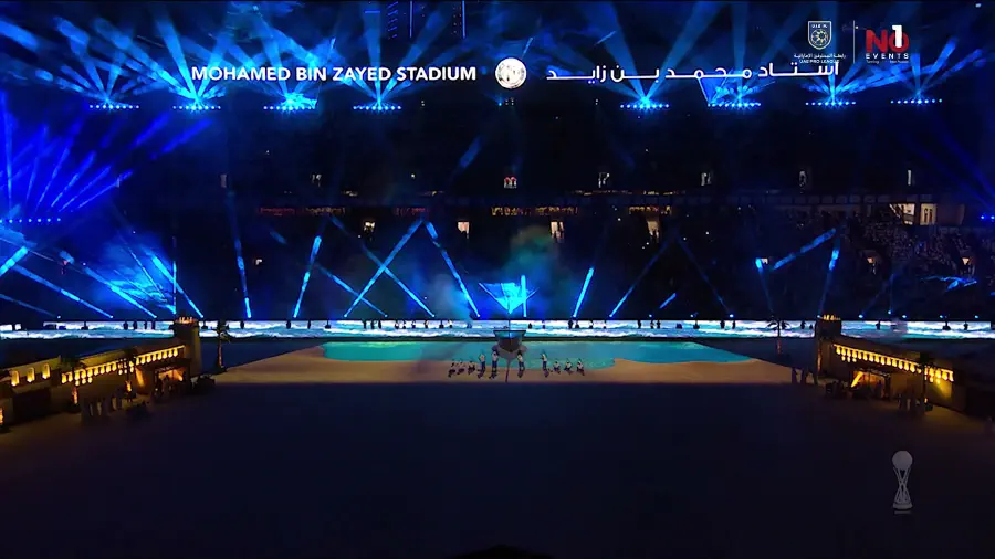 Wide view of the stadium bowl with blue beams crossing above the pitch