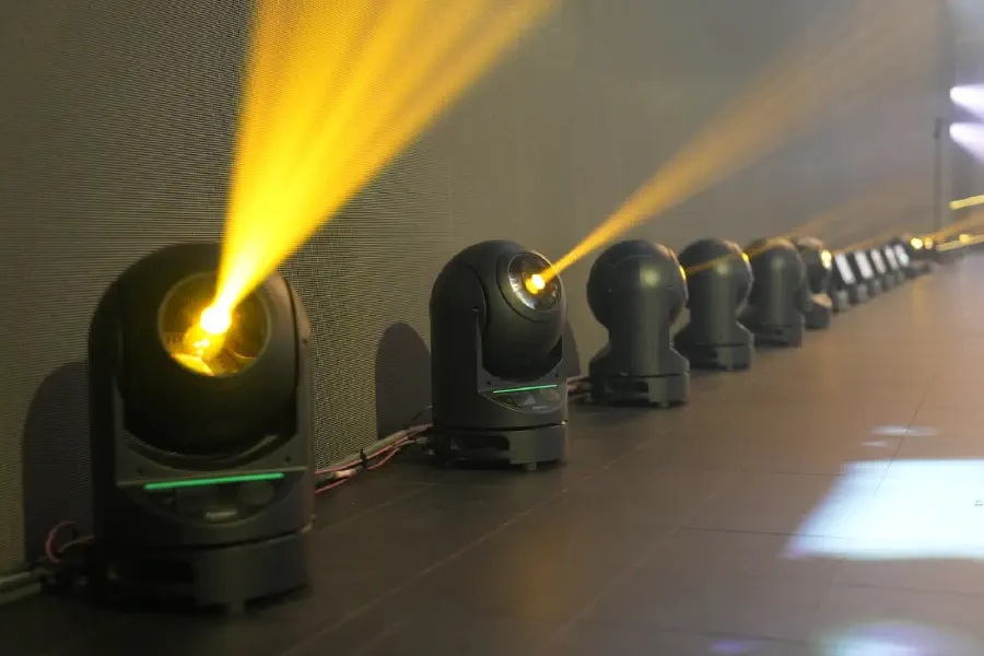 A row of Ayrton moving heads backstage with one fixture struck and running